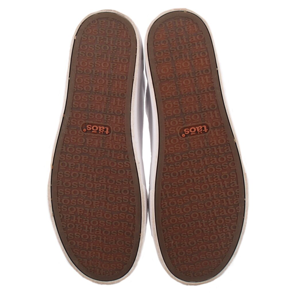 White leather sneaker insoles showing 'taos' pattern and logo