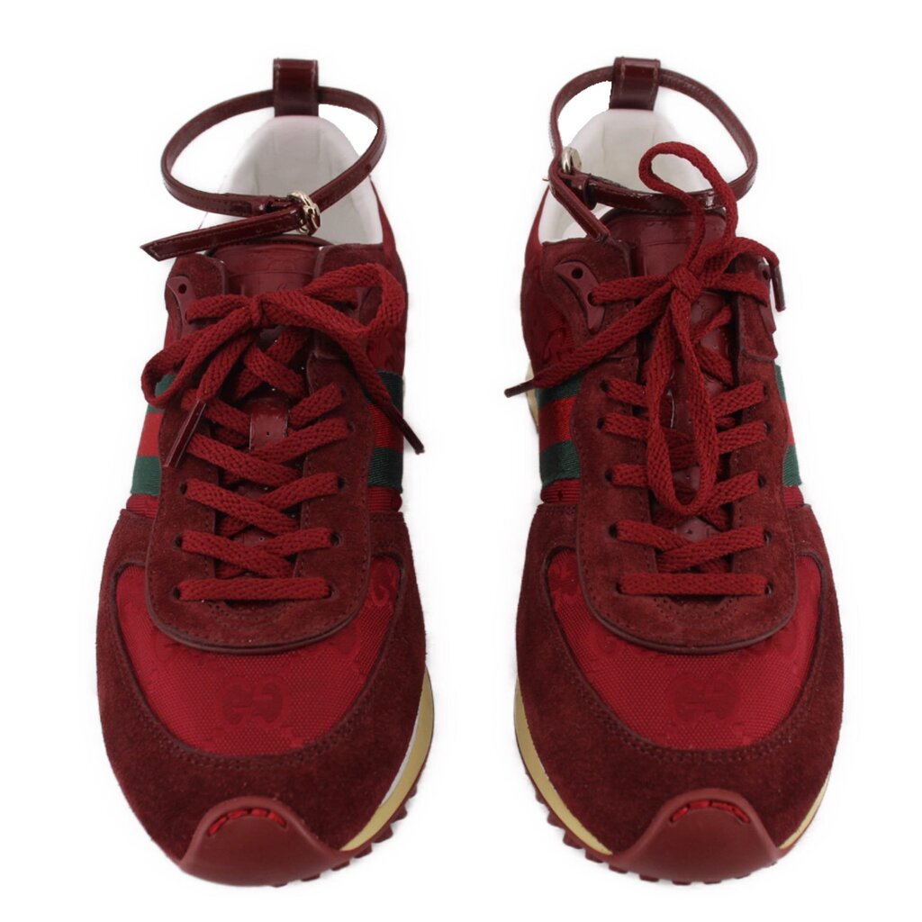 Pair of red lace-up sneakers with textured suede panels and beige outsoles