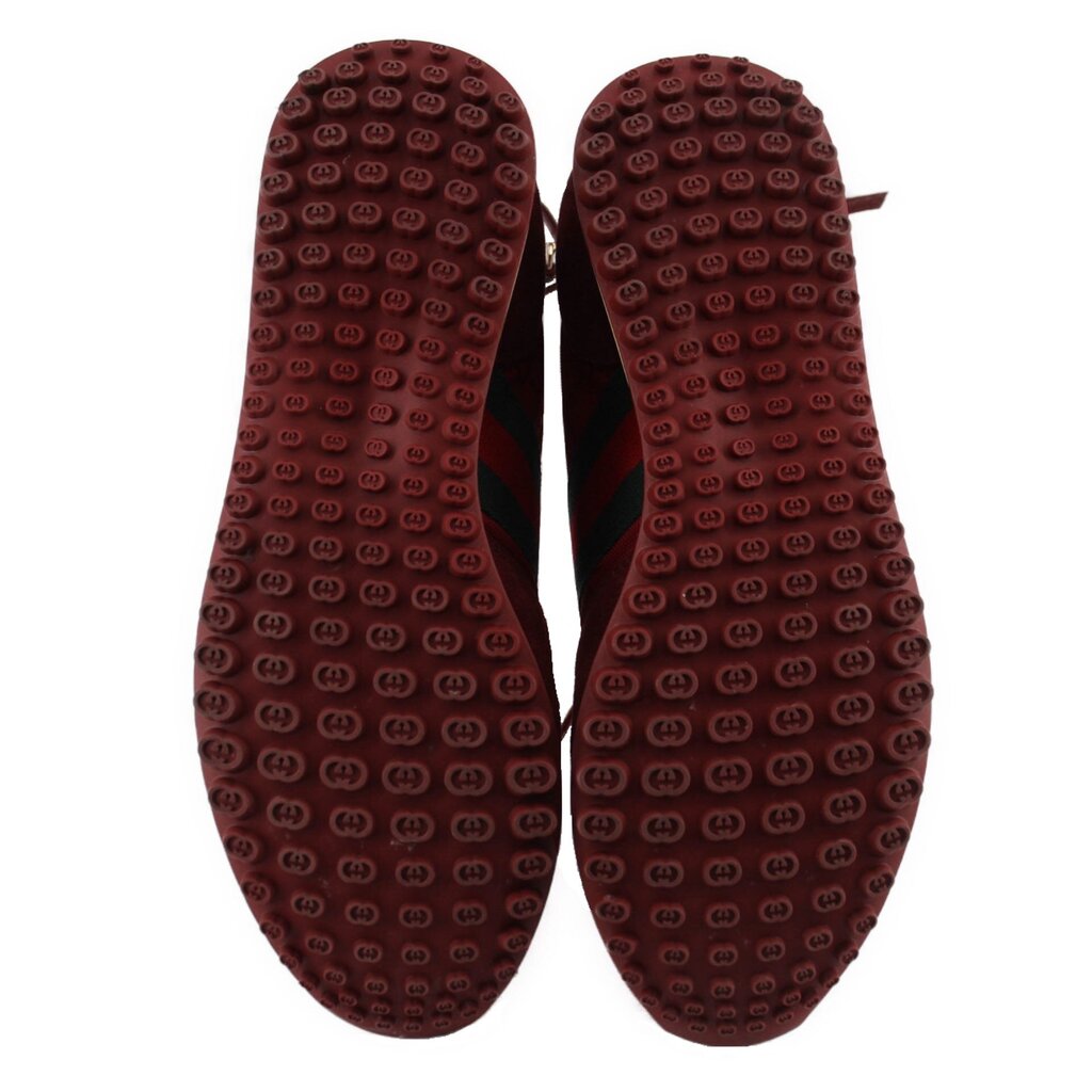 Red rubber sneaker outsoles with repeating logo tread pattern