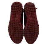Red rubber sneaker outsoles with repeating logo tread pattern
