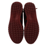 Red rubber sneaker outsoles with repeating logo tread pattern