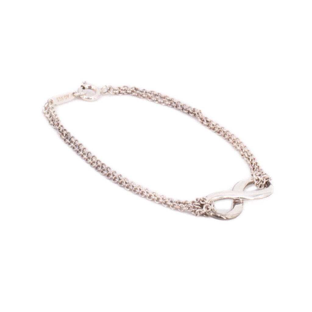 Silver-tone infinity link bracelet with chain and round clasp detail