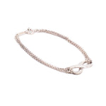 Silver-tone infinity link bracelet with chain and round clasp detail