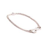 Silver-tone infinity link bracelet with chain and round clasp detail