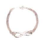 Silver-tone chain bracelet featuring an infinity knot centerpiece