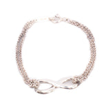 Silver-tone chain bracelet featuring an infinity knot centerpiece