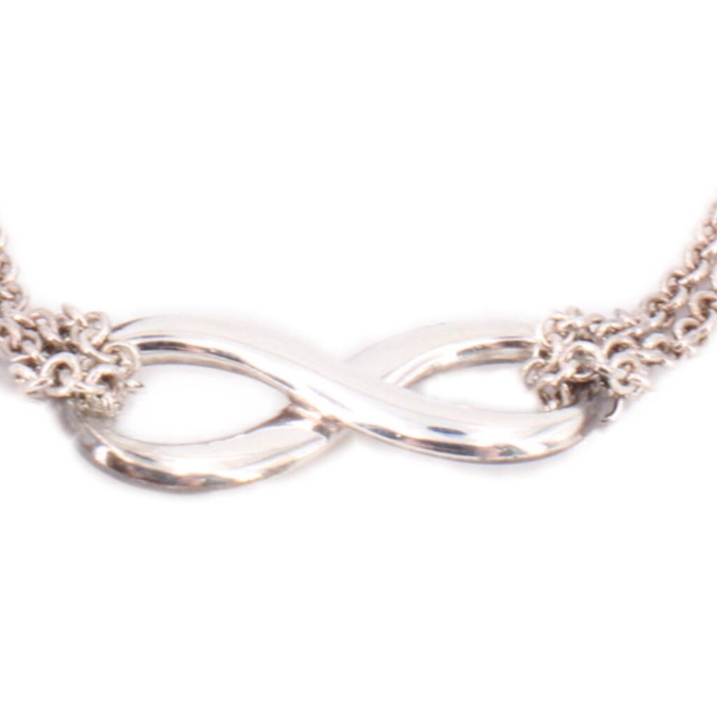 Silver-tone infinity knot bracelet with close-up of linked centerpiece