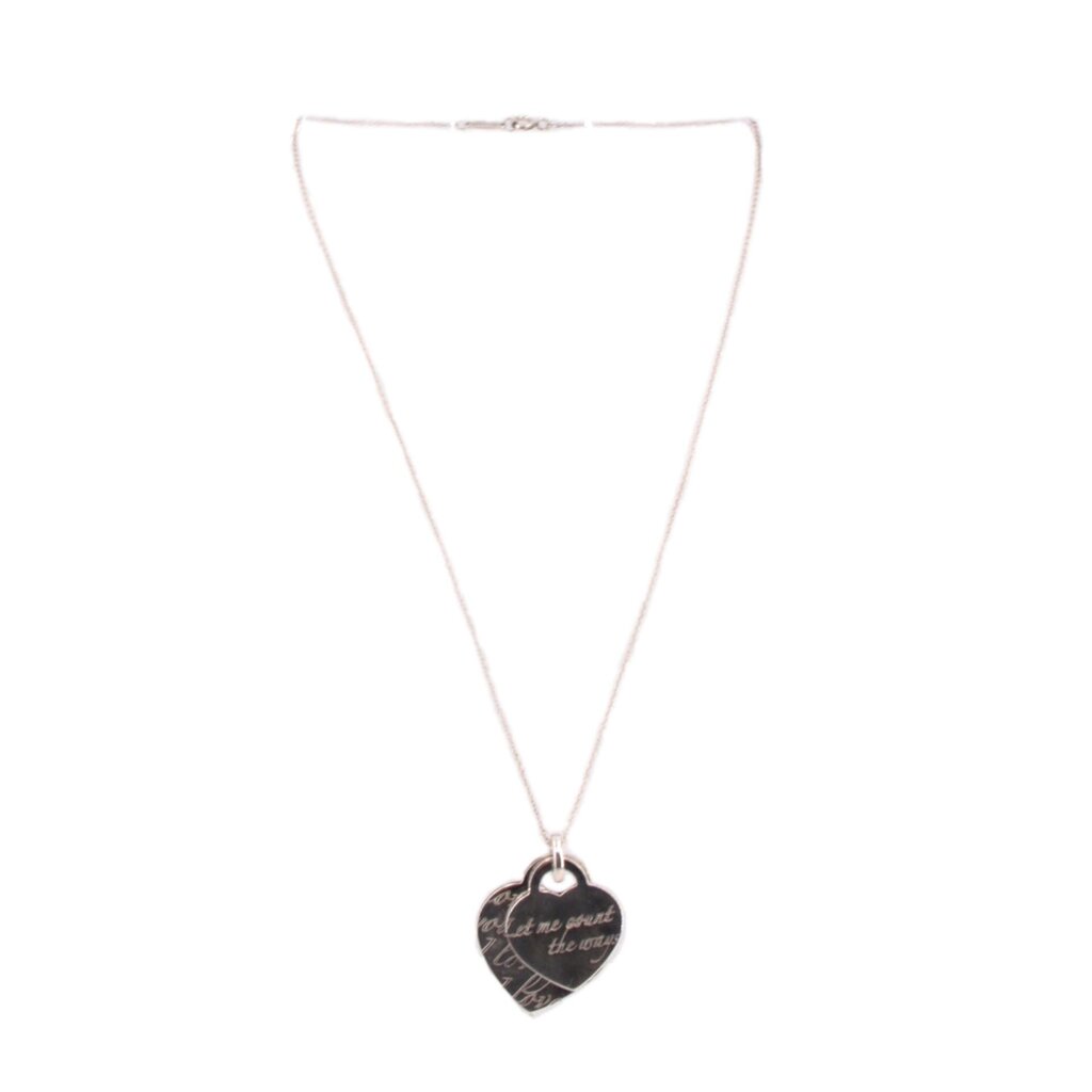 Silver heart pendant necklace with dark heart charm on a thin chain