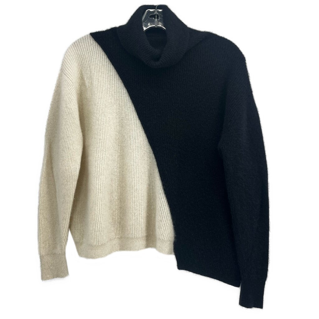 Two-tone turtleneck sweater, black and cream panels, long sleeves.