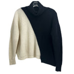 Two-tone turtleneck sweater, black and cream panels, long sleeves.