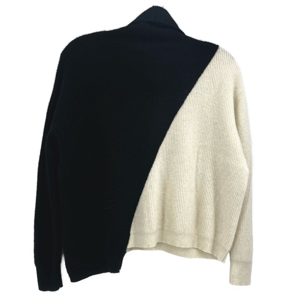 Two-tone turtleneck sweater, black and cream panels, back view, long sleeves.
