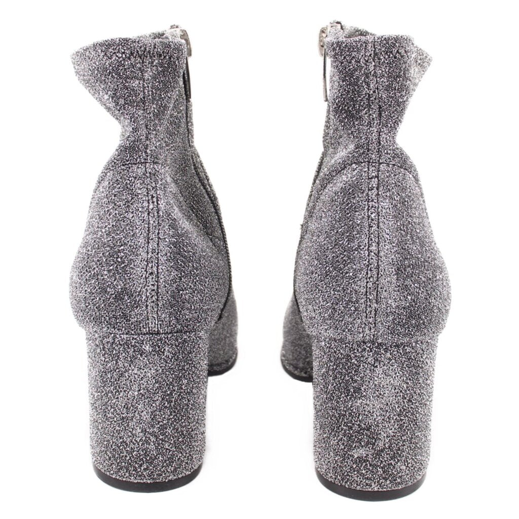 Metallic silver ankle bootie pair showing chunky block heel and side seams