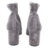 Metallic silver ankle bootie pair showing chunky block heel and side seams