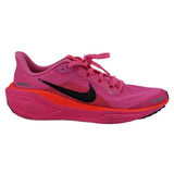 Pink running sneaker side view with black swoosh and orange accent midsole.