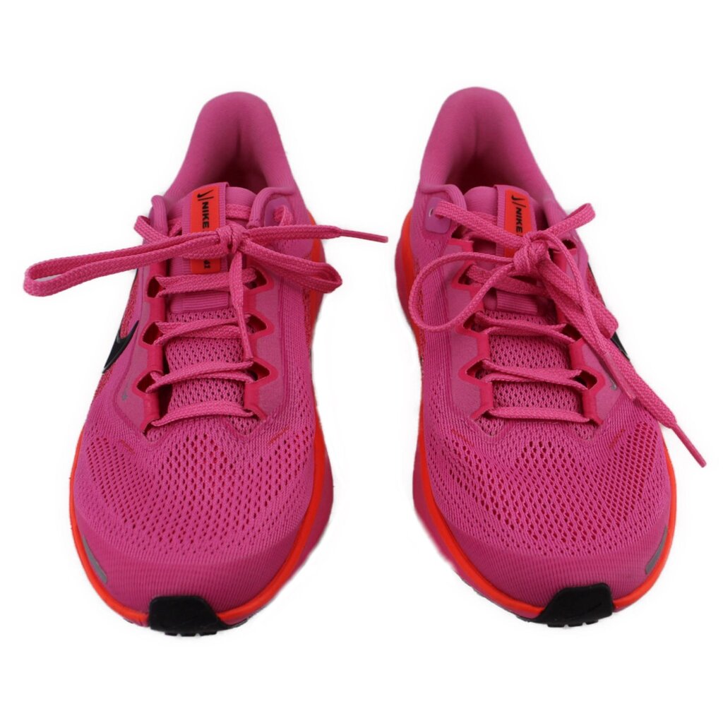 Pair of pink lace-up running sneakers with textured mesh uppers and orange soles.