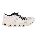 White ON Cloud mesh sneakers, side profile with black lace-up and tread sole