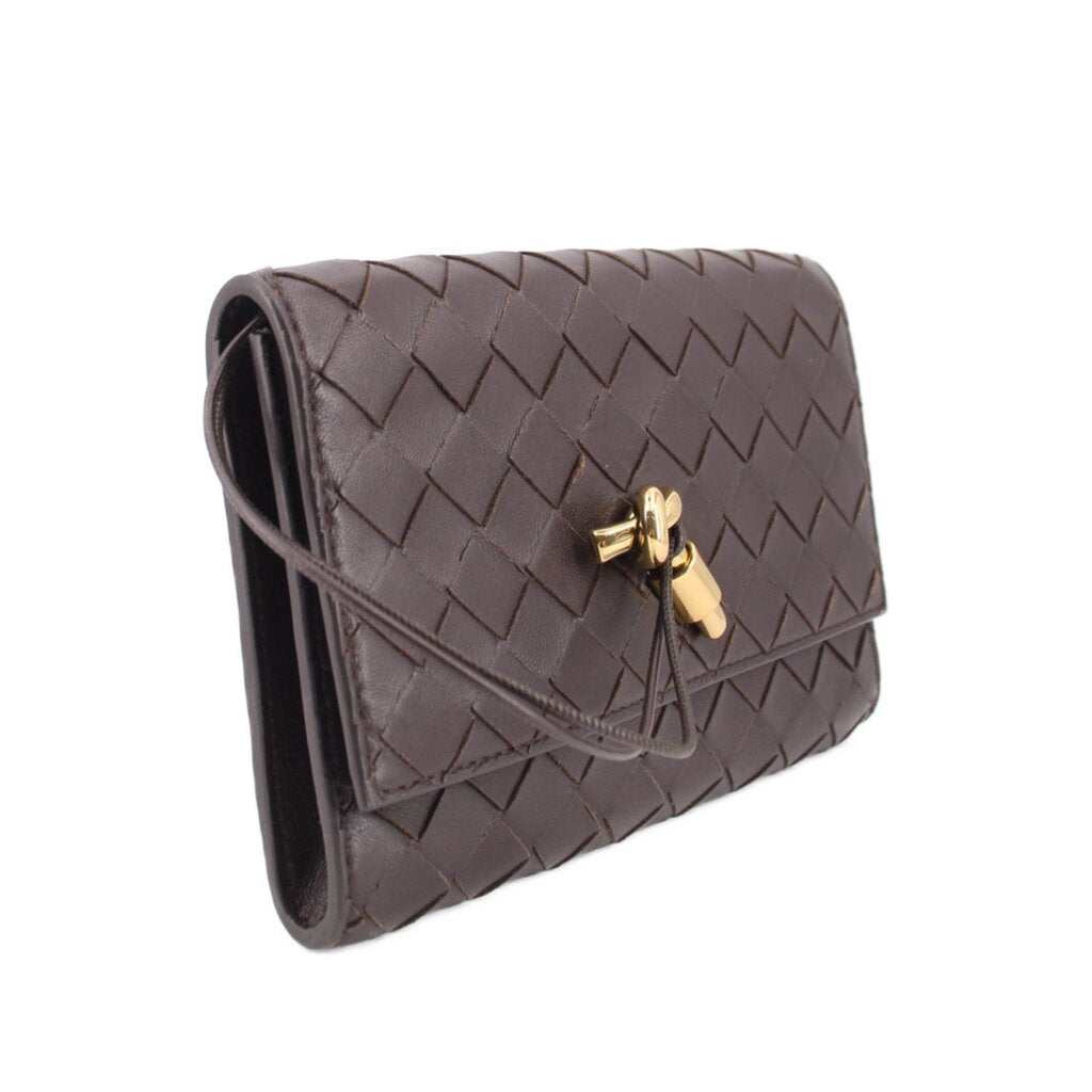 Chocolate woven leather crossbody pouch with flap and gold-tone clasp, side view