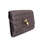 Chocolate woven leather crossbody pouch with flap and gold-tone clasp, side view