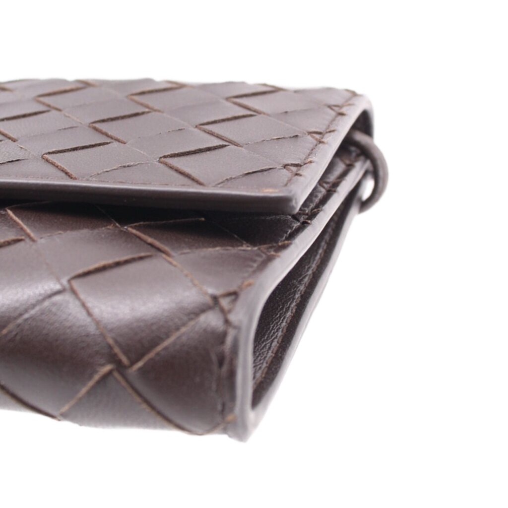 Chocolate woven leather crossbody pouch corner with metal ring and stitched edge