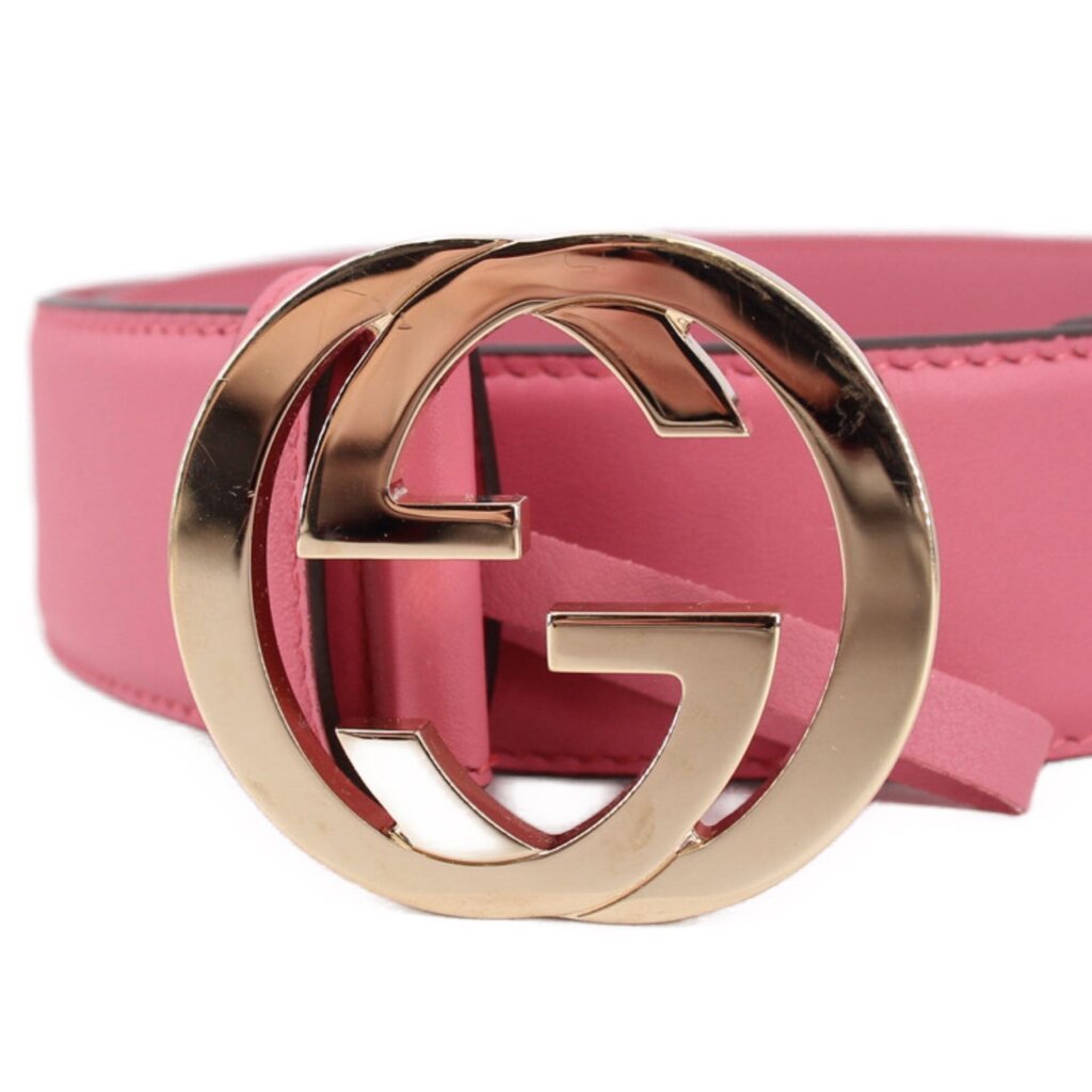 Pink leather belt with large Gucci GG interlocking buckle detail, gold-tone finish