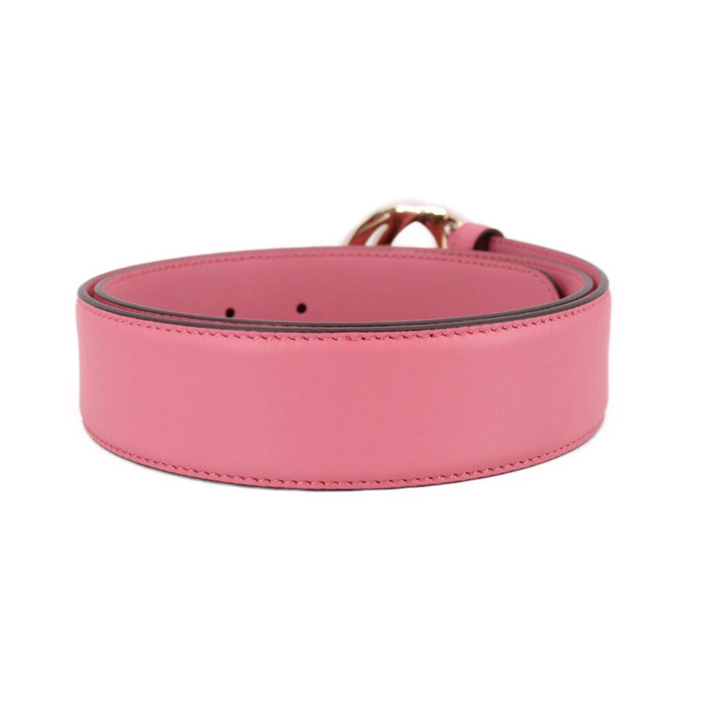 Pink leather belt with perforated adjustment holes and stitched edge