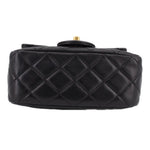 Black quilted mini crossbody bag with diamond pattern and top handle loop