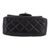 Black quilted mini crossbody bag with diamond pattern and top handle loop