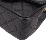 Close-up of black quilted leather mini crossbody bag corner and diamond stitching