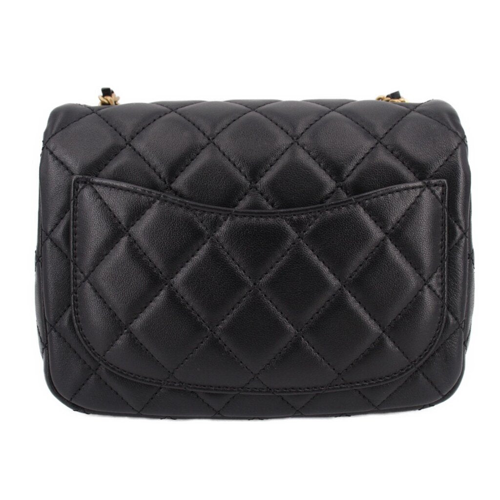 Black quilted mini crossbody bag back view with flap and stitched diamond pattern
