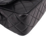 Close-up of black quilted leather mini crossbody bag front quilting with curved seam