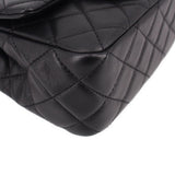 Close-up of black quilted leather mini crossbody bag front quilting with curved seam