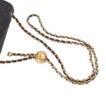 Gold-tone chain strap with clasp on black quilted mini crossbody bag