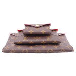Monogram canvas Kirigami pouch set stacked with front flap and snap closure