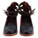 Pair of black strappy heels with ankle straps and red interior lining