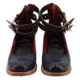 Pair of black strappy heels with ankle straps and red interior lining