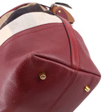 Burgundy leather corner with gold-tone stud and check canvas top edge detail