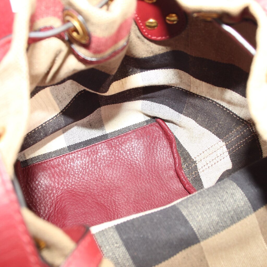 Interior view of check canvas bucket bag with burgundy leather lining
