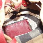 Interior view of check canvas bucket bag with burgundy leather lining
