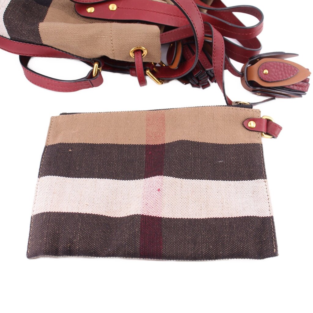 Check canvas bucket crossbody bag with burgundy leather trim and adjustable strap