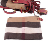 Check canvas bucket crossbody bag with burgundy leather trim and adjustable strap