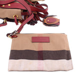 Check canvas crossbody pouch with burgundy label and attached strap hardware