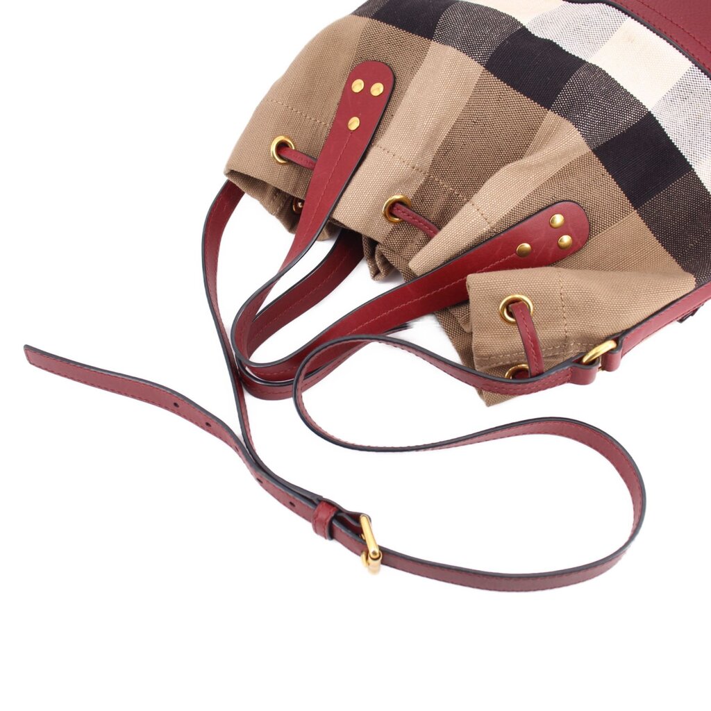Check canvas bucket crossbody bag, burgundy shoulder strap and gold-toned hardware