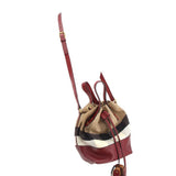 Small bucket crossbody bag with check canvas body, burgundy leather strap and drawcord