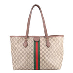 Large tote bag featuring GG monogram print, brown leather handles and center stripe.