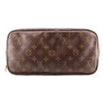 Monogram zip pouch with dark canvas exterior and rounded top zipper edge