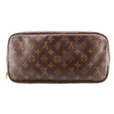 Monogram zip pouch with dark canvas exterior and rounded top zipper edge