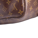 Close-up corner of monogram zip pouch showing leather edge trim and stitching