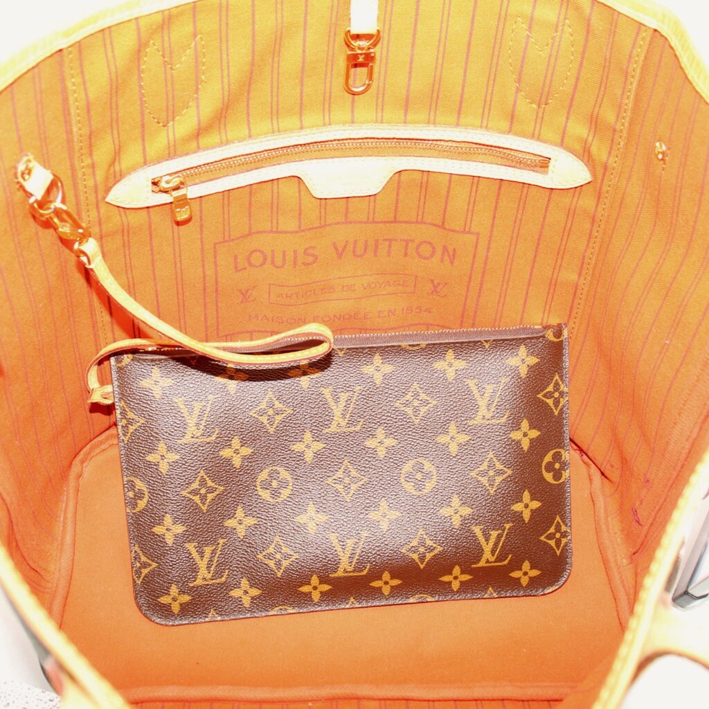 Tote bag interior with striped lining and monogram pocket featuring top zipper