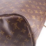 Close-up of monogram zip pouch corner with dark leather trim and stitched edge