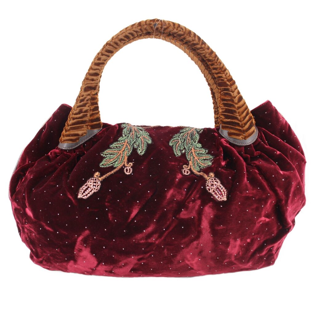 Maroon velvet mini bag with top handles and subtle dotted texture, embroidered accents